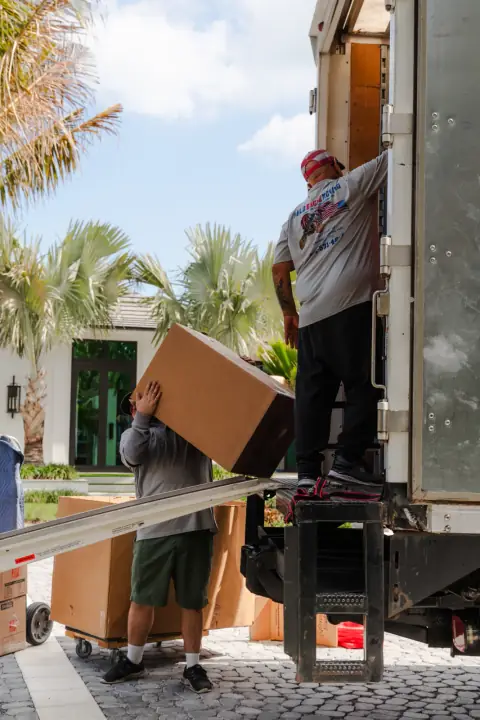 Bald Eagle Moving crew loading boxes into a branded moving truck