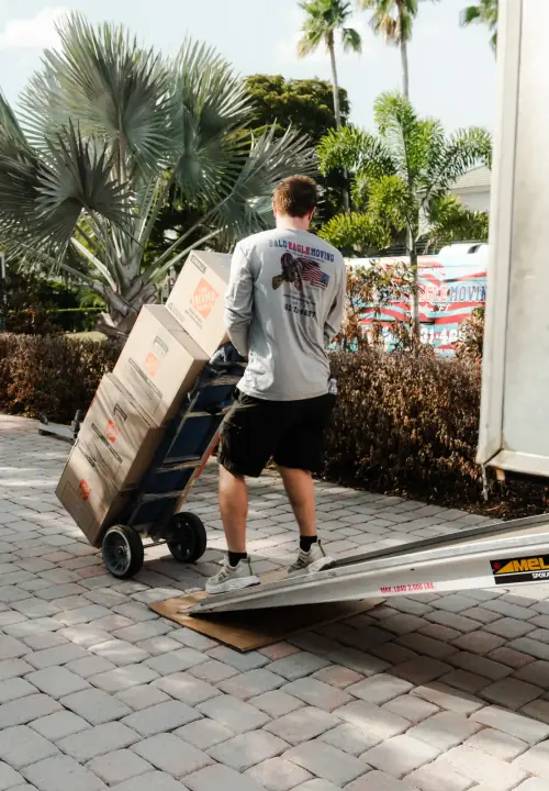 Bald Eagle Moving crew loading boxes on a hand truck