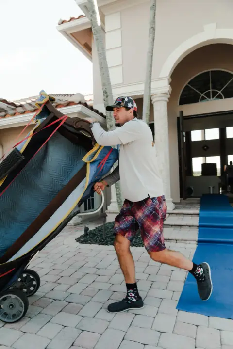 Bald Eagle Moving crew carrying a protected item at a South Florida home